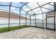 Covered screened-in patio featuring pavers and view of the fenced backyard and lawn at 2752 Bellewater Pl, Oviedo, FL 32765