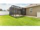 Large screened-in patio with brick flooring, perfect for outdoor relaxation and entertaining in a well-maintained backyard at 2752 Bellewater Pl, Oviedo, FL 32765