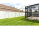 Enclosed screened patio with brick floors overlooks the green backyard, offering privacy with a white vinyl fence at 2752 Bellewater Pl, Oviedo, FL 32765