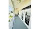Covered balcony with a seating area and a railing, offering a relaxing outdoor space at 276 Celebration Blvd, Celebration, FL 34747