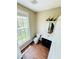 Bright half bathroom with a vanity, toilet, window, and stylish light fixture at 276 Celebration Blvd, Celebration, FL 34747