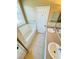 Well-lit bathroom with double sinks, tiled floors, and a bathtub with a shower at 276 Celebration Blvd, Celebration, FL 34747