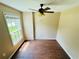 Cozy room with wood-look floors, a ceiling fan, and a large window letting in natural light at 276 Celebration Blvd, Celebration, FL 34747