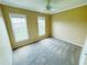 Spacious, bright bedroom with two windows, carpeted flooring, and neutral paint at 276 Celebration Blvd, Celebration, FL 34747