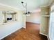 Open-concept dining area with views of the kitchen and a spacious living area, wood look floors at 276 Celebration Blvd, Celebration, FL 34747