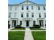 Elegant three-story townhouse featuring manicured landscaping and classic architectural details at 276 Celebration Blvd, Celebration, FL 34747
