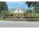 Community center with beautiful landscaping, palm trees, and a covered porch at 276 Celebration Blvd, Celebration, FL 34747