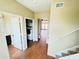 Hallway leading to a laundry room, staircase and living area with wood-look floors at 276 Celebration Blvd, Celebration, FL 34747