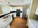 Bright kitchen with stainless steel appliances, black backsplash, white cabinets, and granite countertops at 276 Celebration Blvd, Celebration, FL 34747