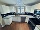 Bright kitchen featuring granite countertops, white cabinetry and stainless steel dishwasher at 276 Celebration Blvd, Celebration, FL 34747