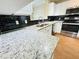 Bright kitchen featuring granite countertops, white cabinetry and stainless steel dishwasher at 276 Celebration Blvd, Celebration, FL 34747