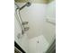 Modern shower with white tile, a handheld shower head, and built-in shelving for storage at 276 Celebration Blvd, Celebration, FL 34747