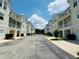 Neighborhood street lined with townhouses, each with a two-car garage and well-maintained landscaping at 276 Celebration Blvd, Celebration, FL 34747