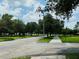 Residential street with manicured lawns and mature trees lining the roadway, creating a tranquil environment at 276 Celebration Blvd, Celebration, FL 34747