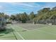Community tennis court featuring a net, benches, and perimeter fencing at 276 Celebration Blvd, Celebration, FL 34747