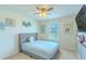 Cozy bedroom with a gray upholstered bed, neutral carpet, and decorative wall art at 2783 Red Horse Dr, Kissimmee, FL 34744