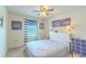 Bright bedroom with a white bed frame, and natural light from a window with blue striped curtains at 2783 Red Horse Dr, Kissimmee, FL 34744