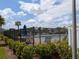 Community pool area with lounge chairs, surrounded by lush landscaping and a secure fence at 2783 Red Horse Dr, Kissimmee, FL 34744