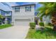 Two-story home featuring a two-car garage, neutral paint, and well-maintained landscaping at 2783 Red Horse Dr, Kissimmee, FL 34744