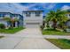 Charming two-story home with a gray exterior, attached garage, and well-manicured landscaping at 2783 Red Horse Dr, Kissimmee, FL 34744