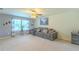 Spacious living room features a large gray sofa, neutral carpet, and lots of natural light at 2783 Red Horse Dr, Kissimmee, FL 34744
