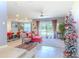Open-concept living room with large windows, ceiling fan, and view of the backyard at 2783 Red Horse Dr, Kissimmee, FL 34744