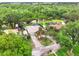 Aerial view of a property featuring a large lot, a swimming pool, lush landscaping, and waterfront access at 28136 Tammi Dr, Tavares, FL 32778