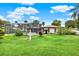 Expansive backyard featuring lush greenery, a screened-in pool, providing a private outdoor space for relaxation at 28136 Tammi Dr, Tavares, FL 32778