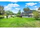Lush backyard featuring an inviting screened pool area and well-maintained green lawn at 28136 Tammi Dr, Tavares, FL 32778