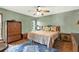 Inviting bedroom featuring hardwood floors, a ceiling fan, and elegant decor at 28136 Tammi Dr, Tavares, FL 32778