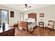 Elegant bedroom with a vintage wood bed frame, wood floors, and bright natural light at 28136 Tammi Dr, Tavares, FL 32778