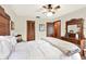 Well-lit bedroom with wood floors and a vintage wood dresser with a decorative mirror at 28136 Tammi Dr, Tavares, FL 32778