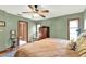 Comfortable bedroom with hardwood floors, soft green walls, and ample natural light at 28136 Tammi Dr, Tavares, FL 32778