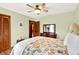 Comfortable bedroom featuring hardwood floors, ceiling fan, and a decorative floral comforter at 28136 Tammi Dr, Tavares, FL 32778