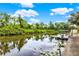 Scenic canal view with boat dock and lush vegetation along the waterway, offering a peaceful waterfront setting at 28136 Tammi Dr, Tavares, FL 32778