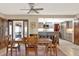 The dining room features a table with seating for four, tile flooring, and a view of the open concept kitchen at 28136 Tammi Dr, Tavares, FL 32778