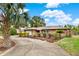 Well-kept single-story home with lovely landscaping, highlighting its inviting curb appeal and established neighborhood setting at 28136 Tammi Dr, Tavares, FL 32778