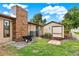 The exterior showcasing a well-maintained yard with a shed and brick chimney, highlighting the home's backyard features at 28136 Tammi Dr, Tavares, FL 32778