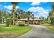 Well-maintained single-story home with lush landscaping and a well-kept front yard, enhancing its welcoming curb appeal at 28136 Tammi Dr, Tavares, FL 32778