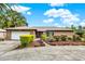 Charming brick home featuring a well-manicured lawn, a two-car garage, and a welcoming front entrance at 28136 Tammi Dr, Tavares, FL 32778