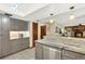 Elegant kitchen with a center island, pendant lighting, stainless steel appliances, and granite countertops at 28136 Tammi Dr, Tavares, FL 32778