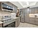 Modern kitchen features stainless steel appliances, gray cabinets, and stylish tile backsplash at 28136 Tammi Dr, Tavares, FL 32778