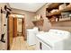 Functional laundry room with washer, dryer, utility sink, and storage shelving at 28136 Tammi Dr, Tavares, FL 32778