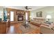Cozy living room featuring a brick fireplace, neutral furniture, and abundant natural light at 28136 Tammi Dr, Tavares, FL 32778
