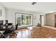 Bright living room featuring wood floors, shutters, and a dedicated workspace, offering a comfortable and functional living space at 28136 Tammi Dr, Tavares, FL 32778