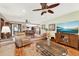 Open floor plan living room area with wood floors, adjacent dining room, modern furniture, and natural light at 28136 Tammi Dr, Tavares, FL 32778