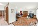 Open-concept living room with hardwood floors, piano, china cabinet, and a workspace at 28136 Tammi Dr, Tavares, FL 32778