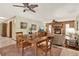 Living and dining areas featuring a fireplace, ceiling fan, tile flooring and wooden furniture at 28136 Tammi Dr, Tavares, FL 32778
