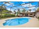 Inviting swimming pool with screened-in enclosure, hot tub, and lush backyard views at 28136 Tammi Dr, Tavares, FL 32778
