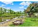 Waterfront backyard with a brick fire pit, seating area, and easy access to the canal for boating at 28136 Tammi Dr, Tavares, FL 32778